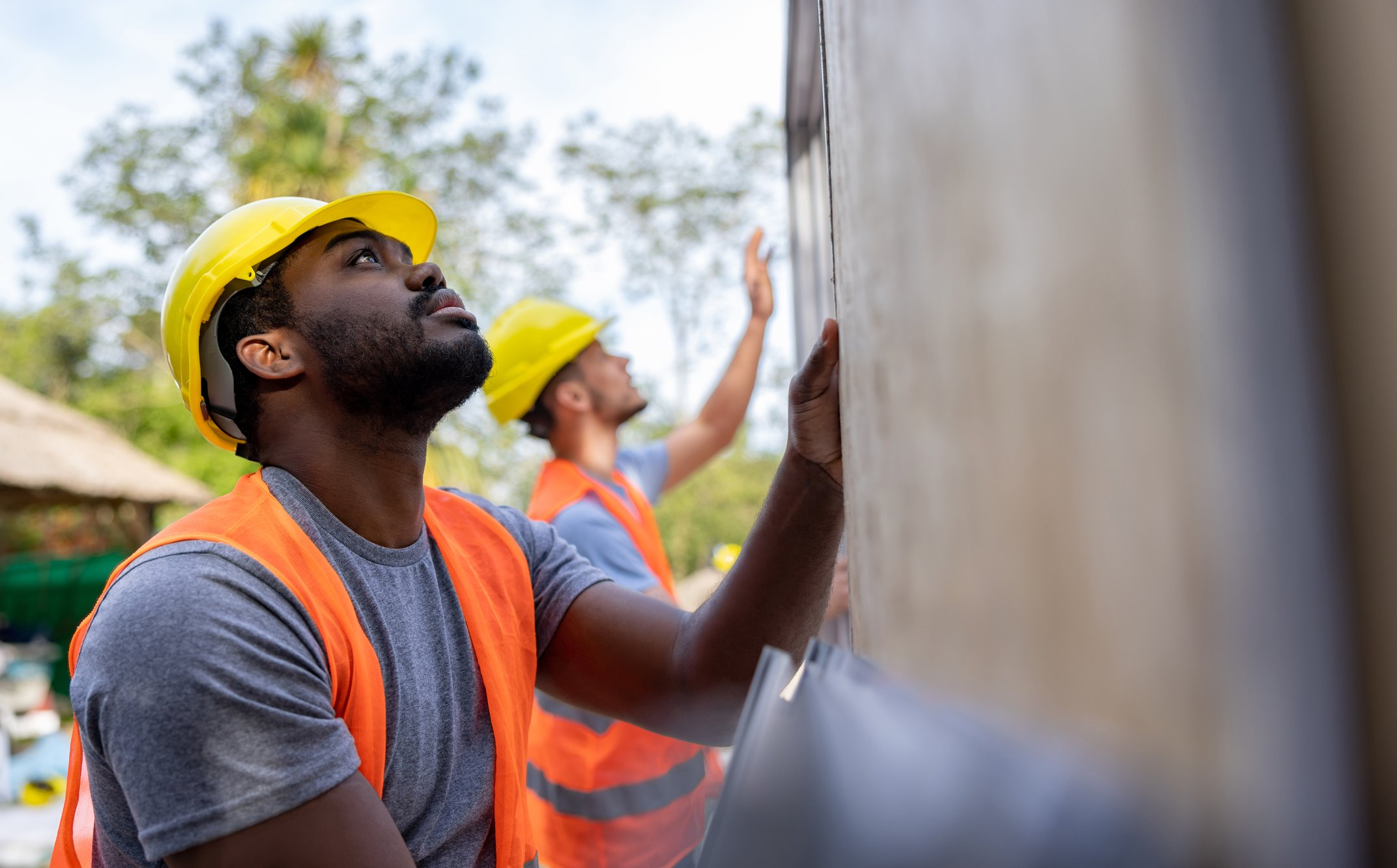 Home restoration company employees installing panels 