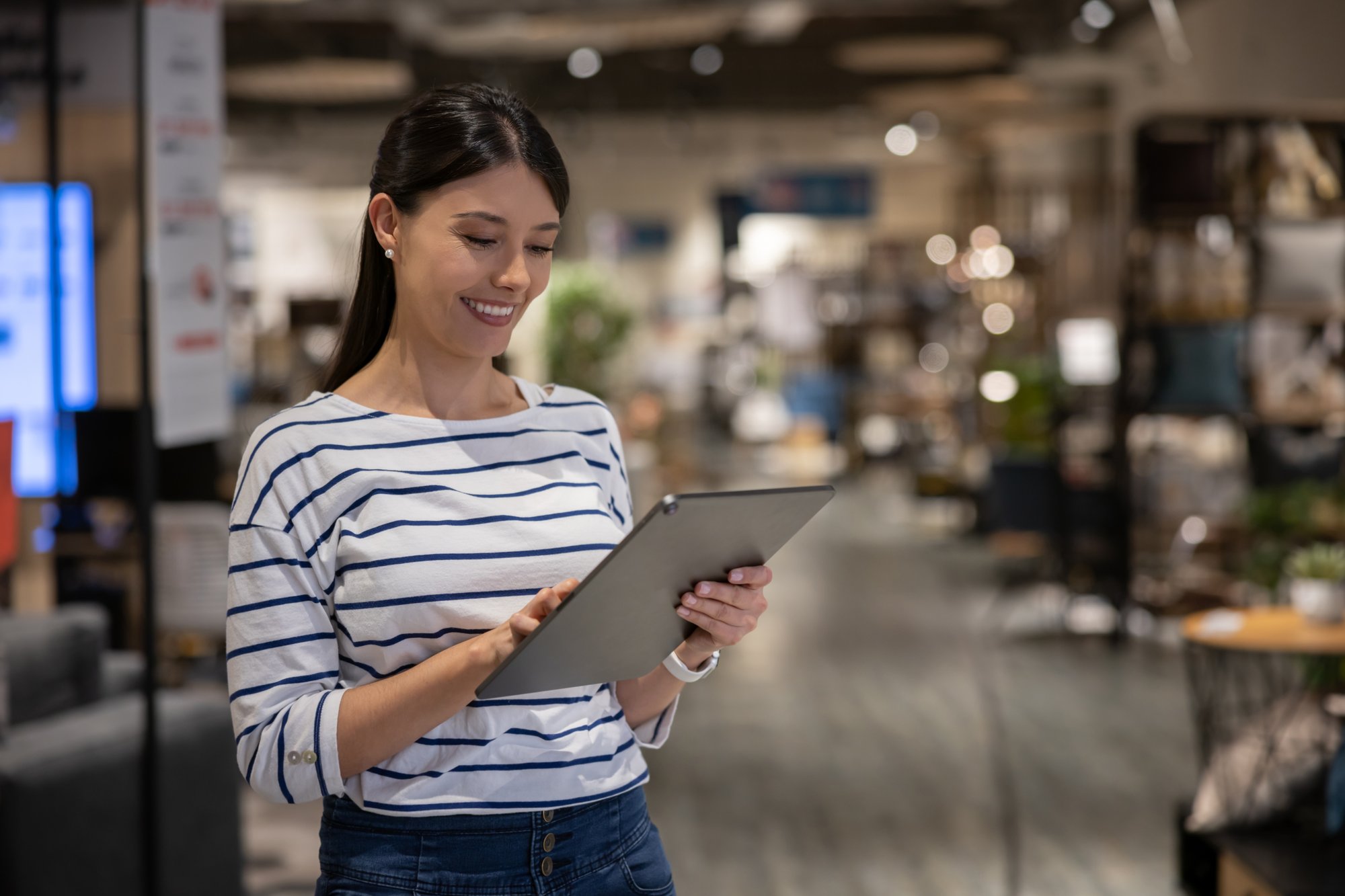 Retail worker on sales floor on tablet